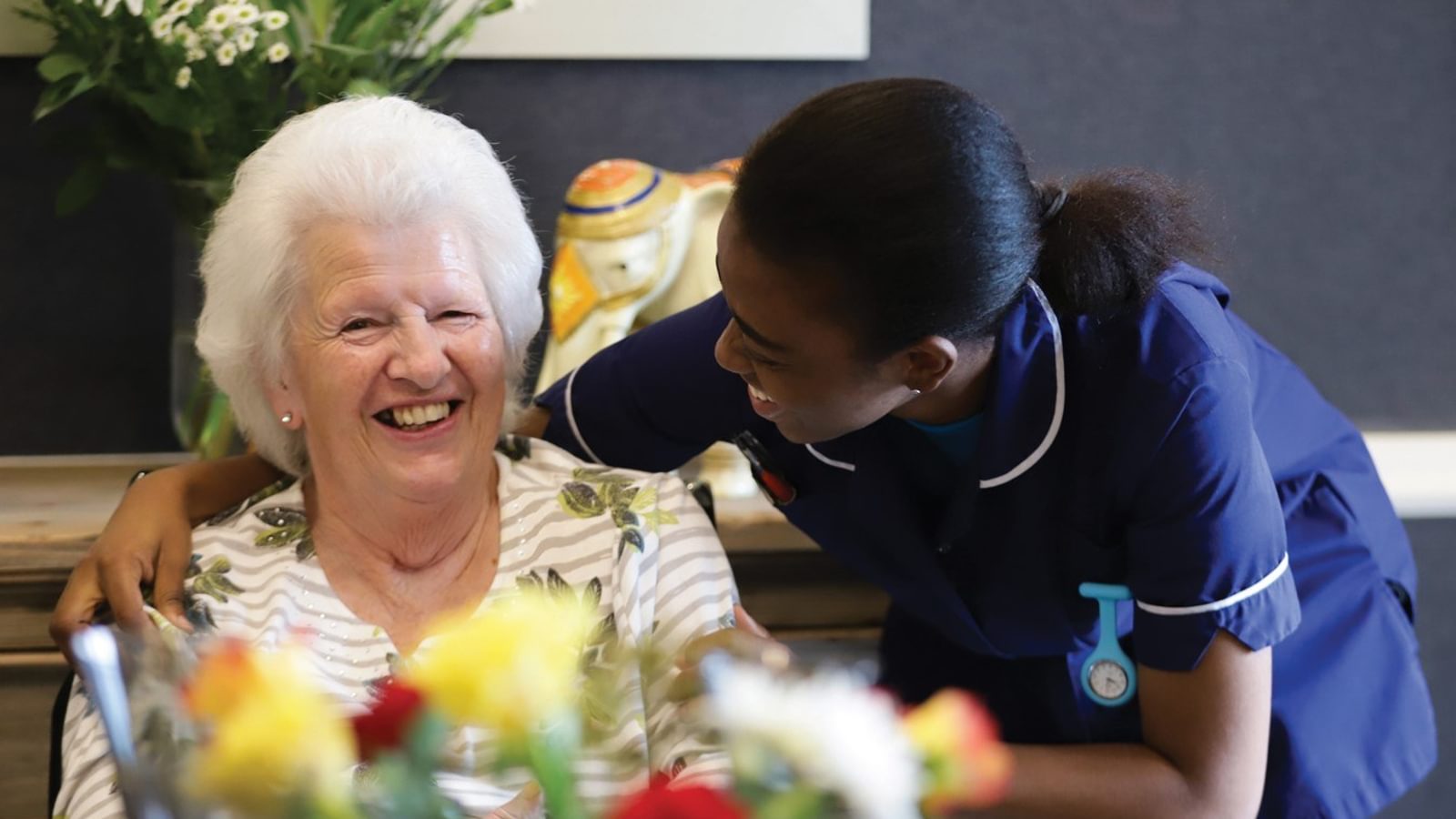 Member of staff at Caring Homes care home caring for elderly resident