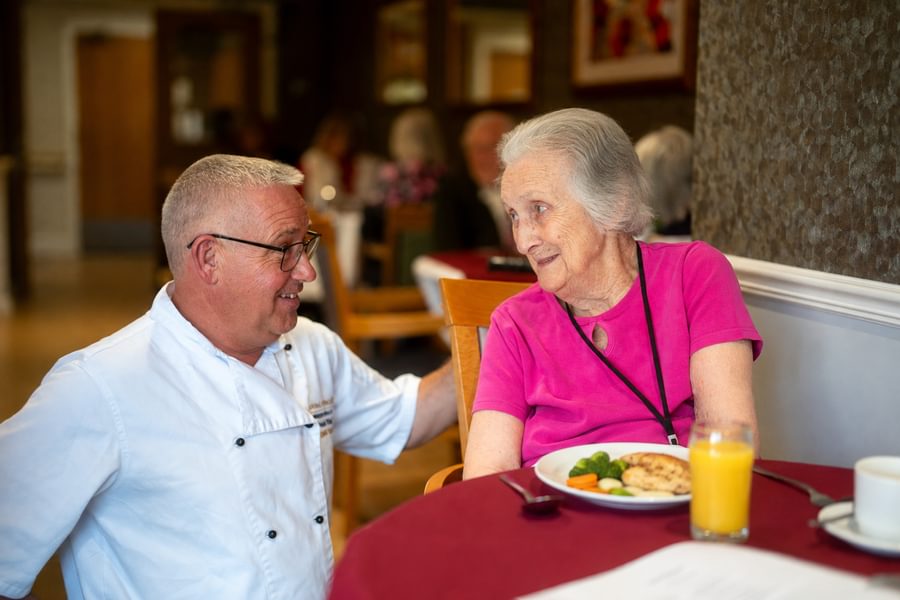 Chef talking to resident