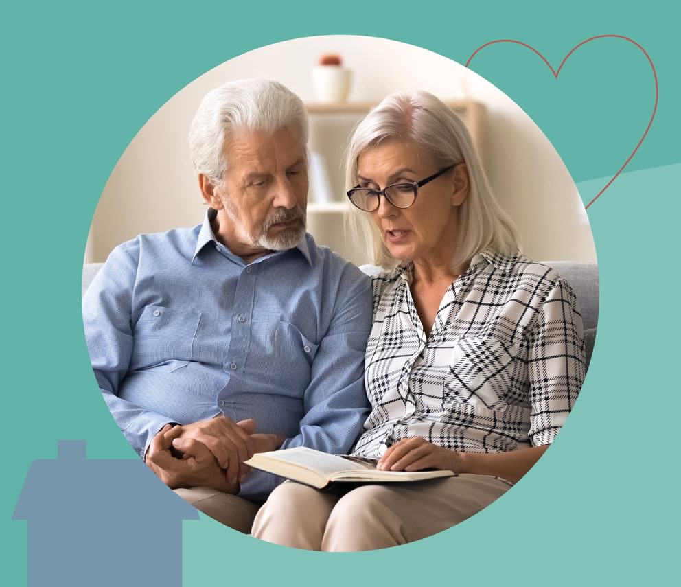 Elderly couple reading information on dementia.