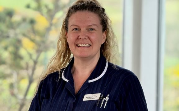 Female nurse clinical trainer in dark blue uniform