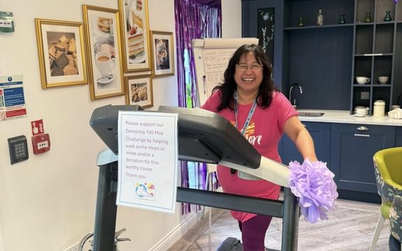 Care Home manager in pink t shirt on treadmill running for Dementia Action Week