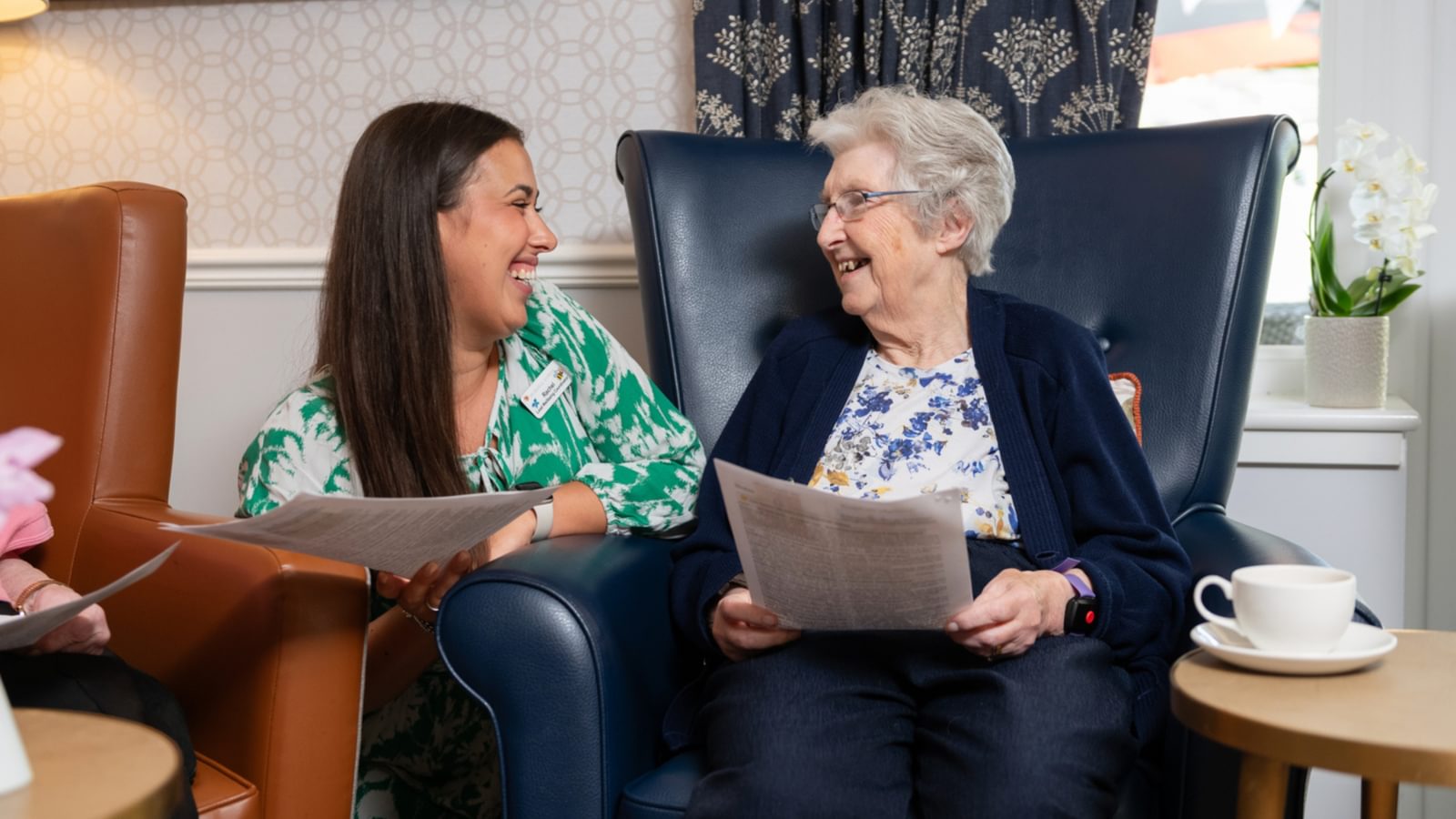 Blenheim Court Care Home Wellbeing coordinator with a resident in a care home