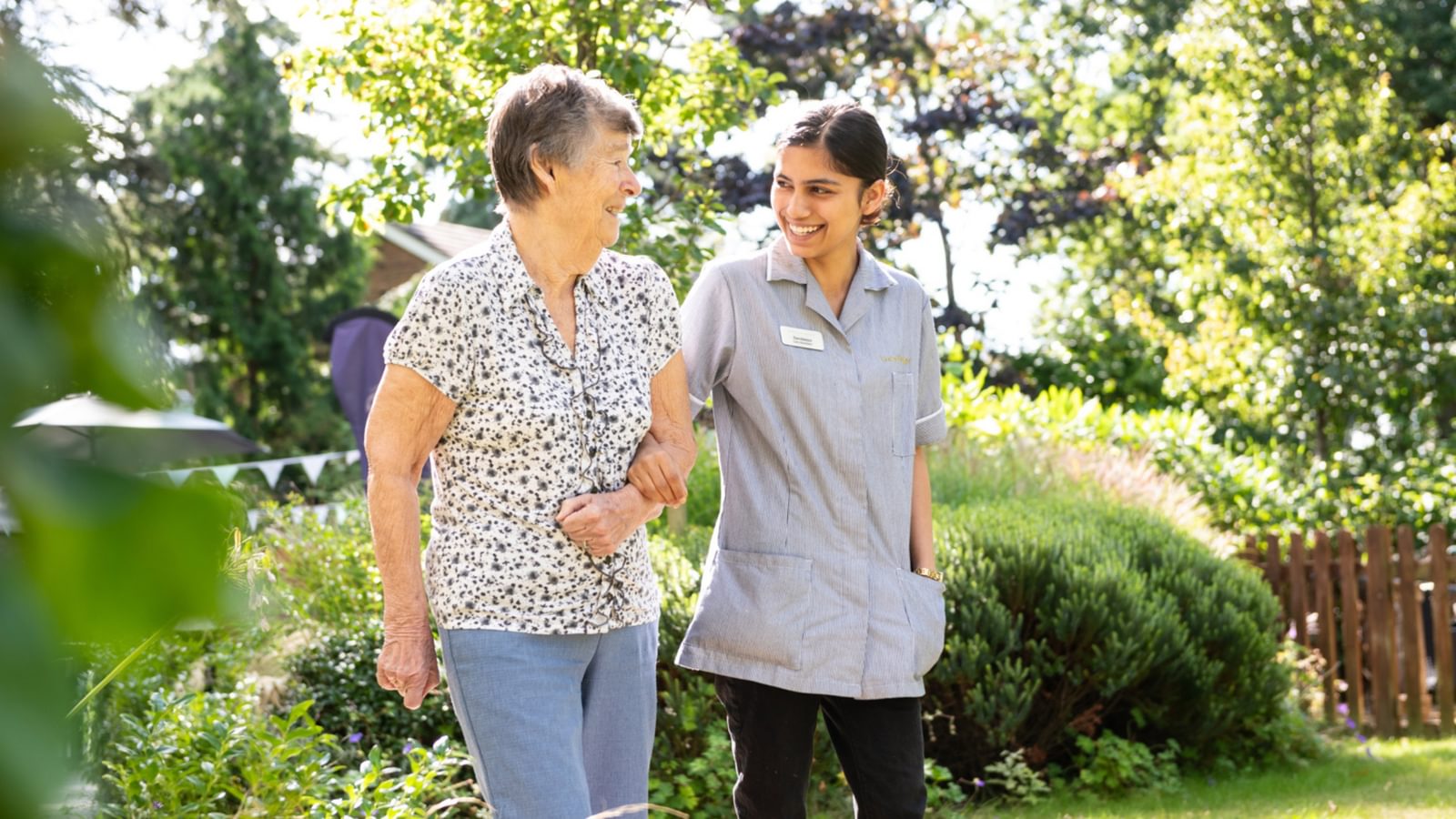 Blenheim Court Care Home resident walking with a carer