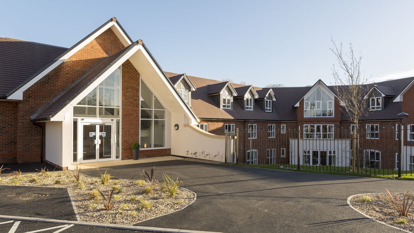 Exterior of Blenheim Court Care Home in Liss with doors to reception