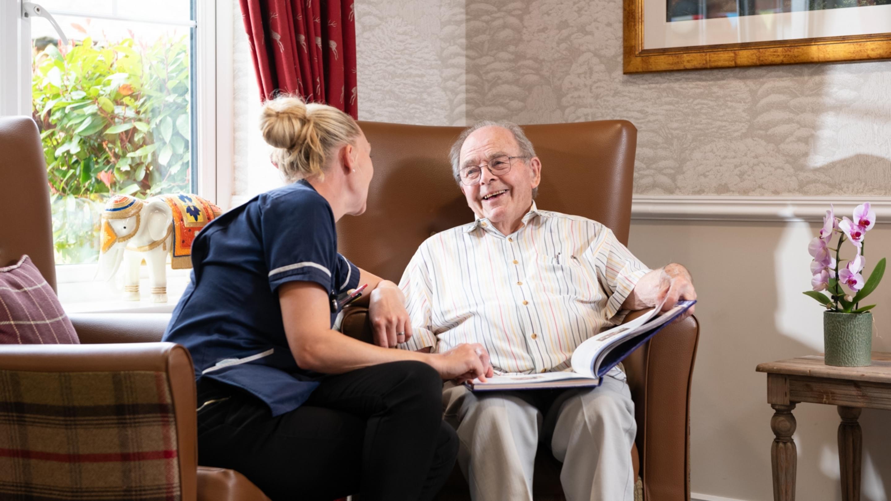 Resident laughing with a Nurse in a care home
