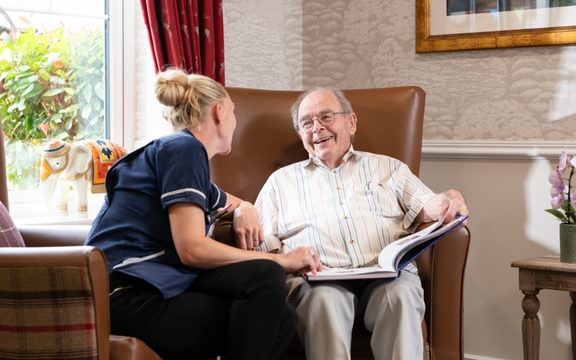 Resident laughing with a Nurse in a care home