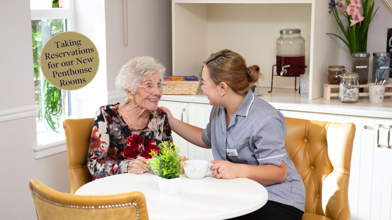 Broadbridge Park Care Home in Horsham, West Sussex, showing resident talking to carer
