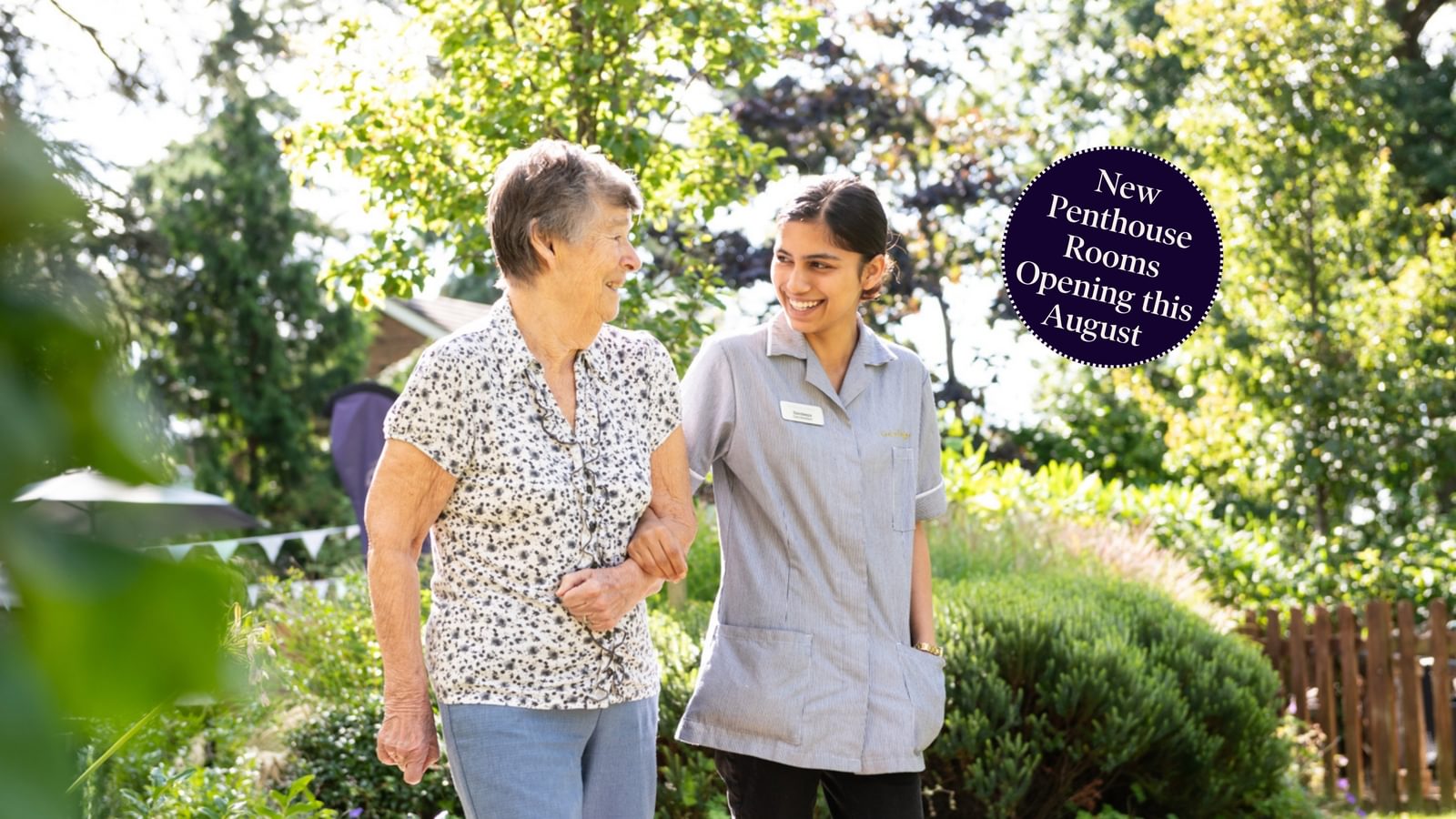 Broadbridge Hero image Resident walking in the garden with a carer