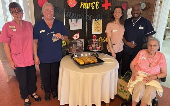 Group of nurses and a resident at a care home
