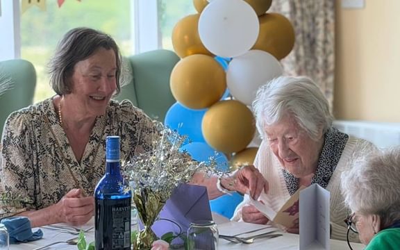 Mildred 103 years old with daughter and cards