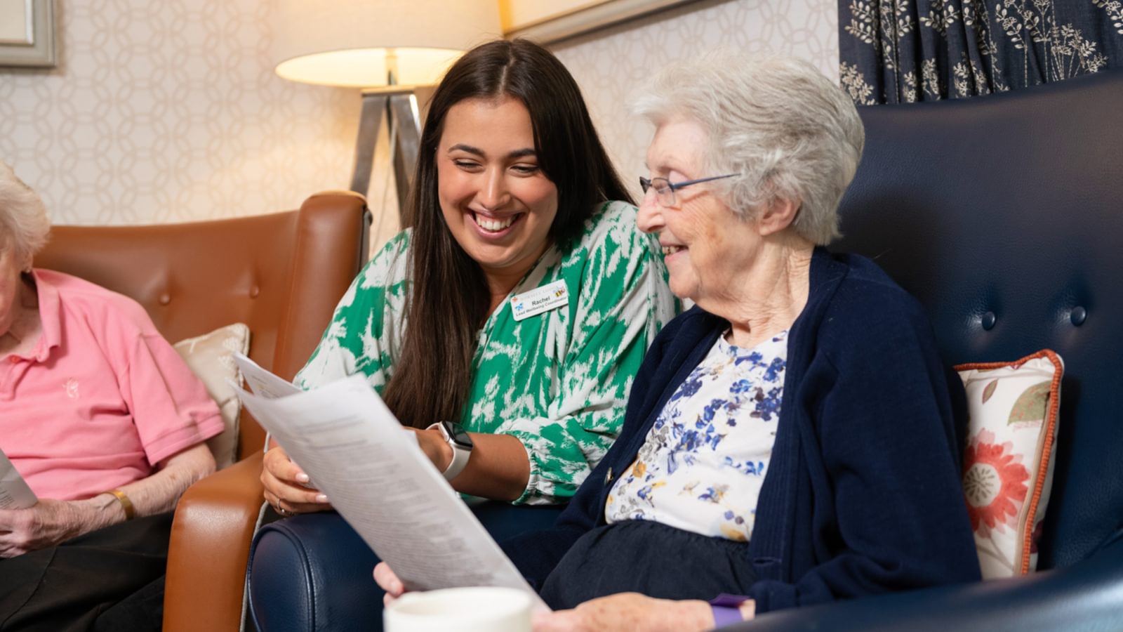 Activities person sitting with resident in care home