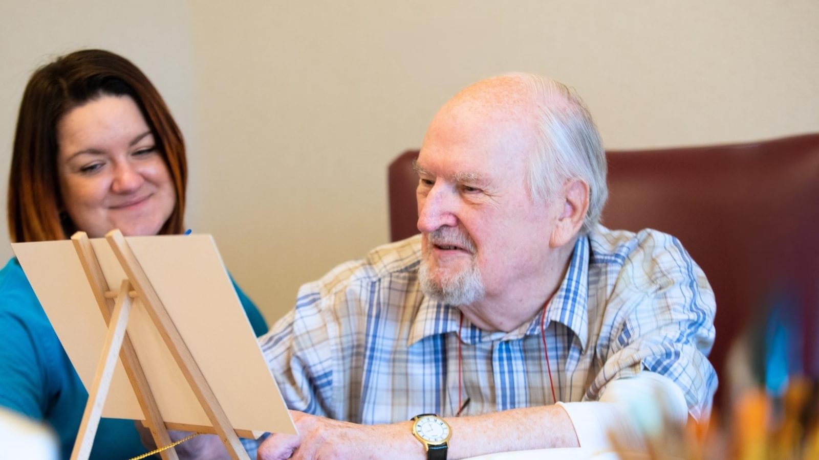 Hawkhill House Care Home Resident painting with carer