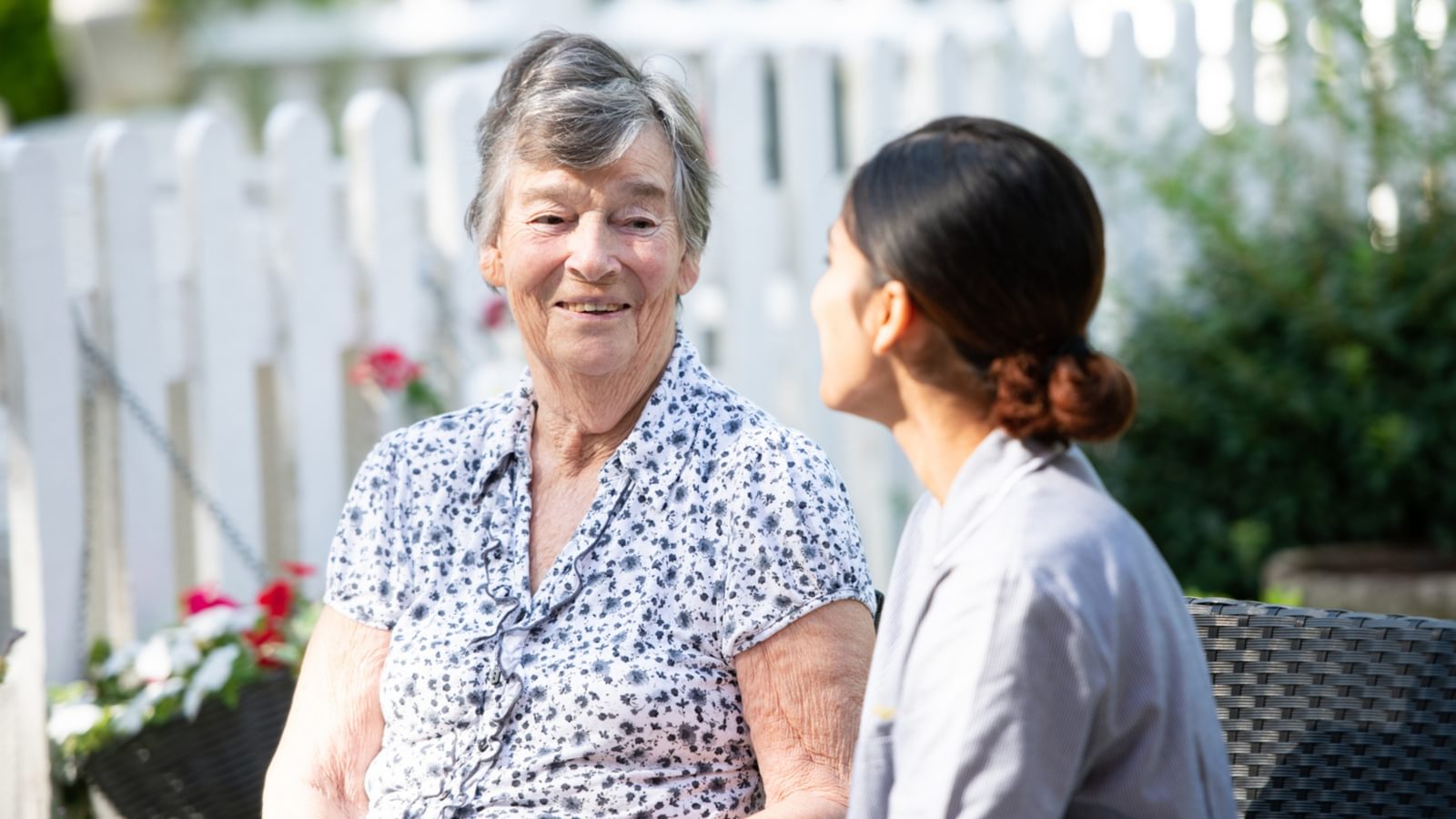 Hawkhill House Care Home resident talking to a Carer in the garden