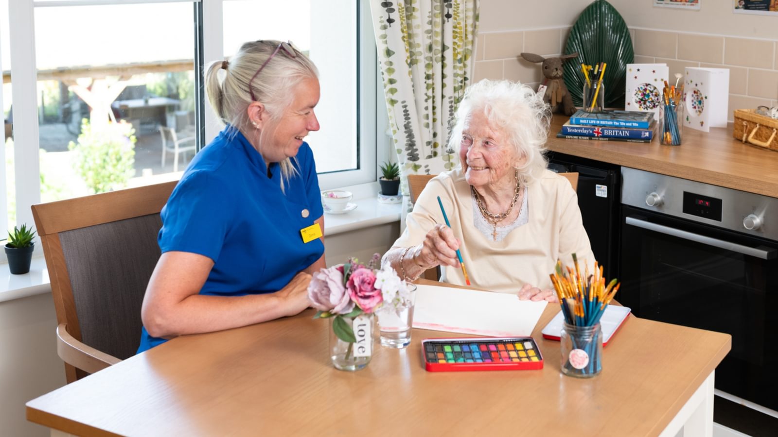 Latham Lodge Care Home Resident playing scrabble with a carer