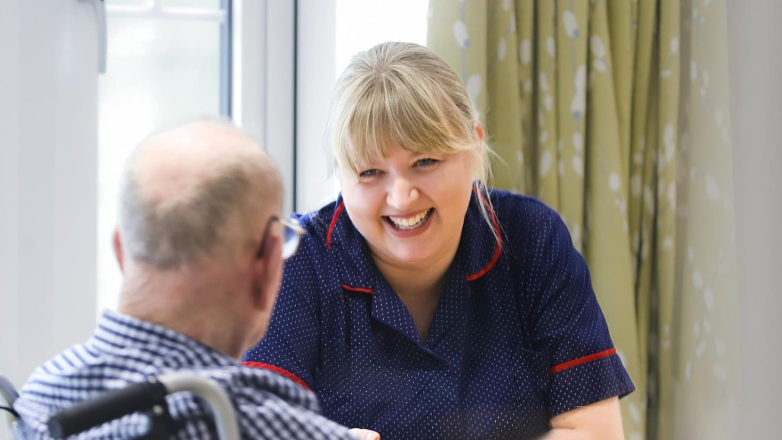 Latham Lodge Care Home elderly man talking to nurse