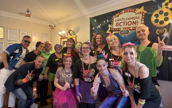 Care Home team in 80s disco clothes