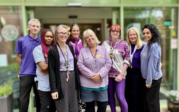 Care home team group wear purple to support Dementia Action Week