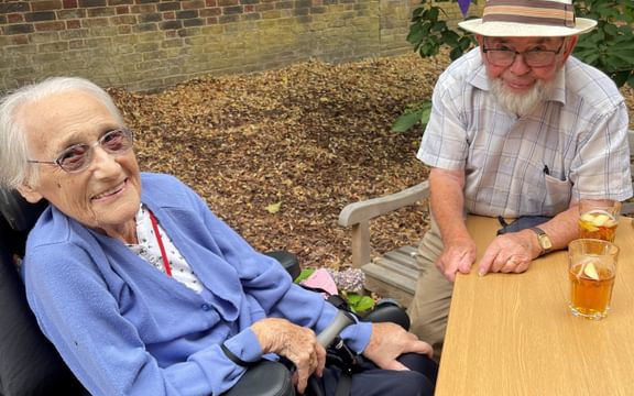 Care home residents enjoy an outdoor barbecue