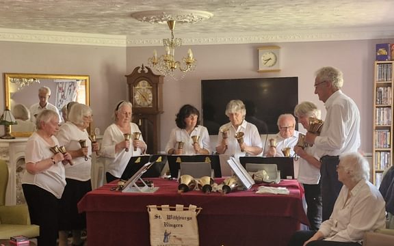 Group of handbell ringers perform for care home residents