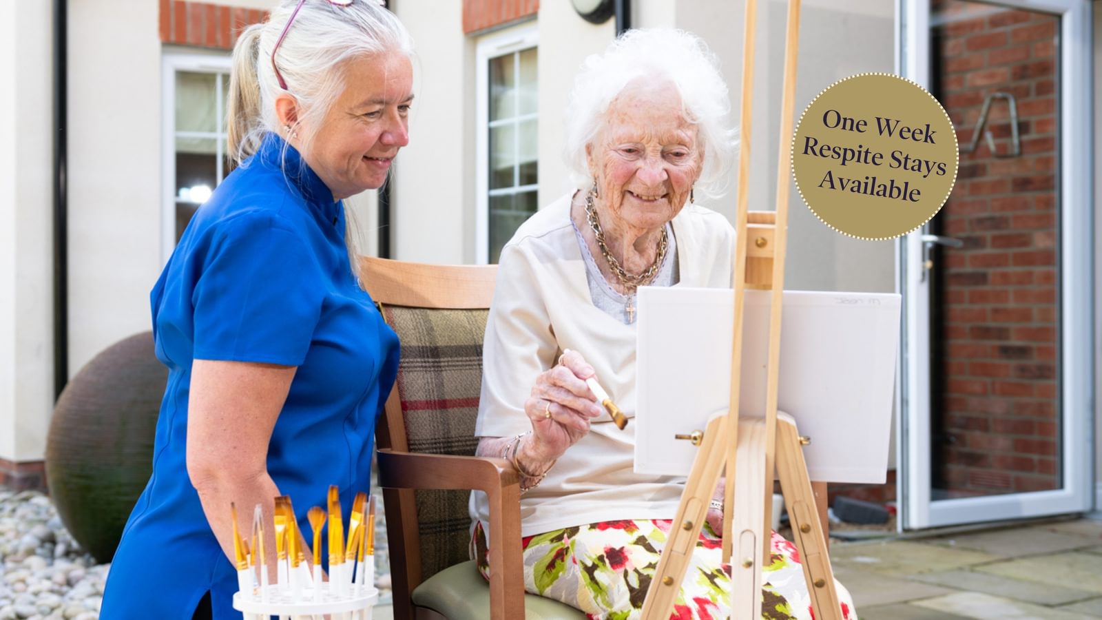 Tarring Manor Care Home Resident painting with carer in the garden
