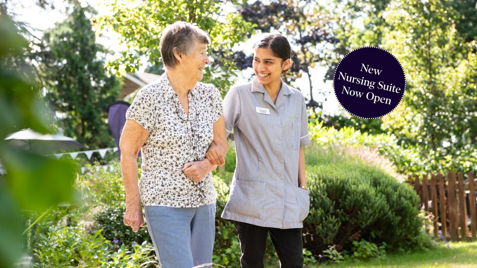 Tarring Manor Care Home resident walking with a carer