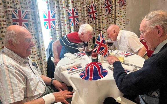 Four male friends at a VE Day lunch