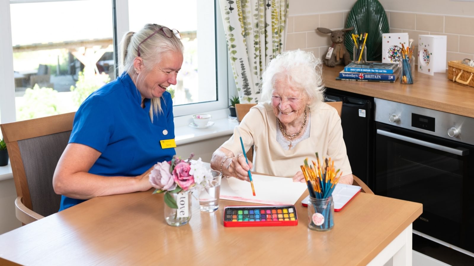 The Orchard Nursing Home in St Albans, Resident painting with a carer