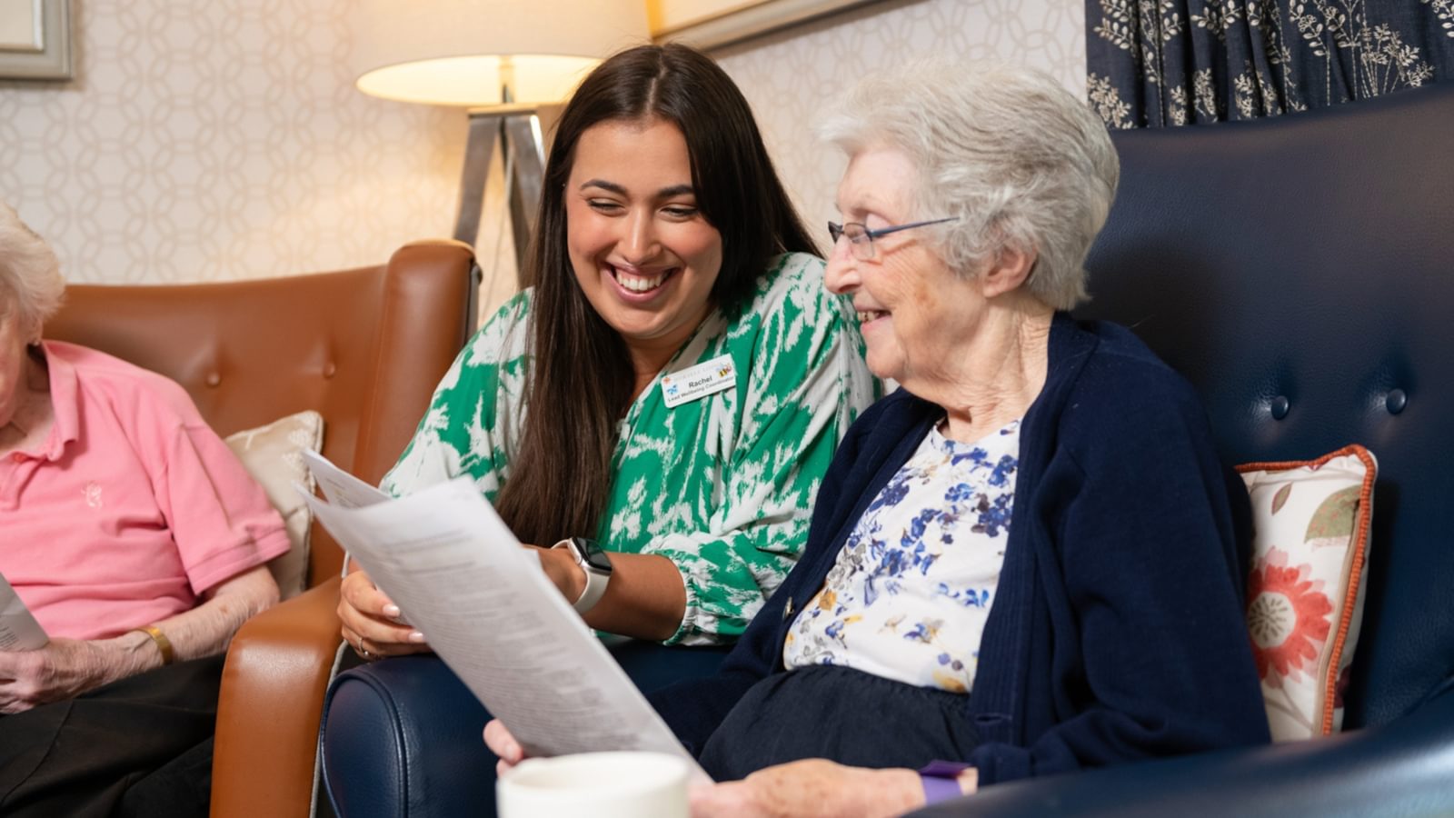 Care home resident with activities coordinator doing an activity