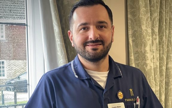 Care home manager in his nurse's uniform