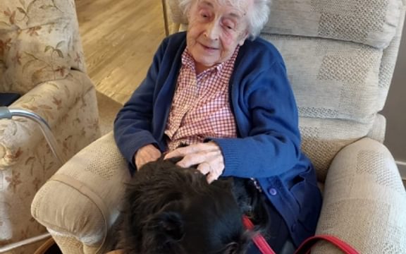Elsa the dog with resident at Brooklyn House Care Home in Attleborough