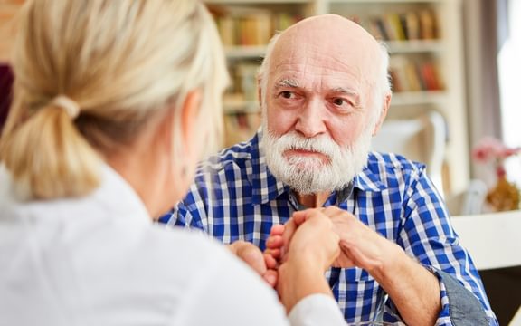 Male resident with a Carer at a Caring Homes care home attending a dementia care event