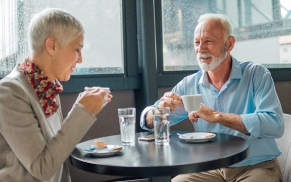 Friendship Cafe - photo of two elderly people enjoying a coffee together