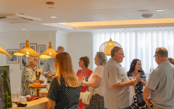 Group of people talking at a networking function