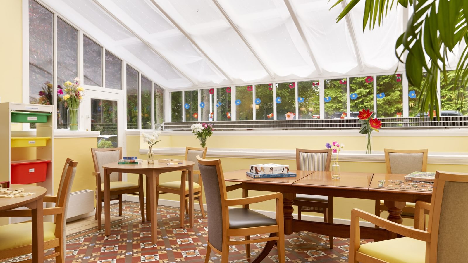 Hawkhill House well lit activity room with table and chairs