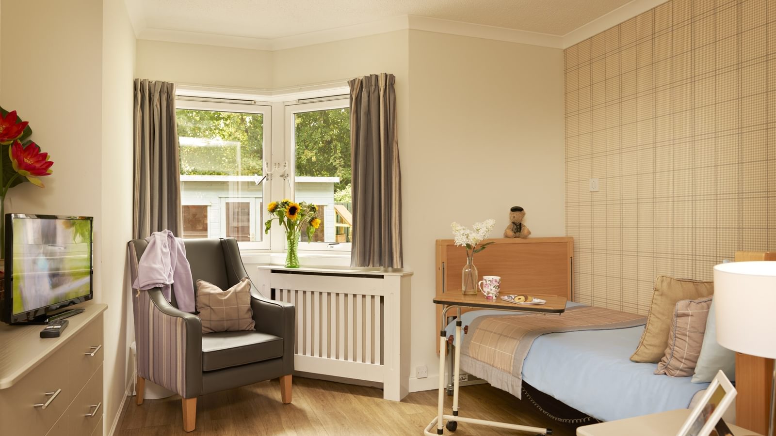 Hawkhill House beautiful bedroom with bed, armchair and TV