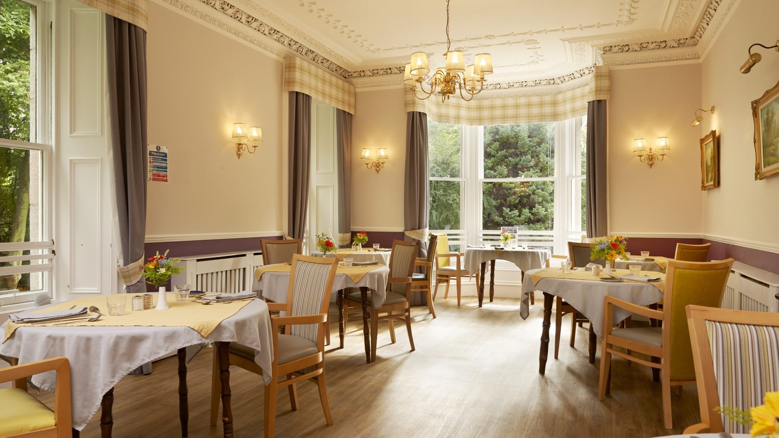 Hawkhill House dining area with tables set up and light flooding into the room