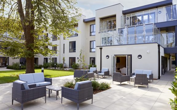External view of Tarring Manor Care Home in Worthing, East Sussex including stylish garden furniture