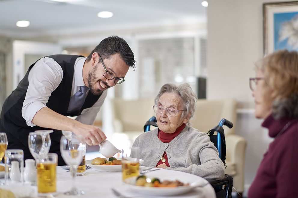 Maitre de serving dinner at ivy court