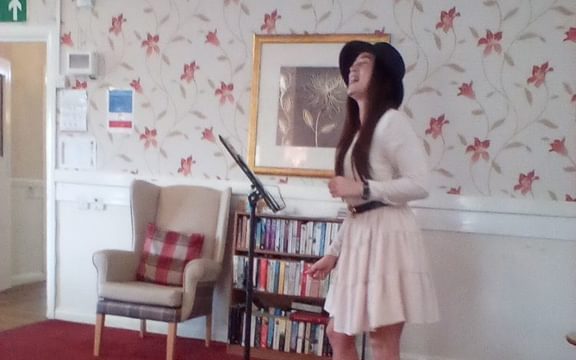 Entertainer singing to residents at Latham Lodge for VE Day