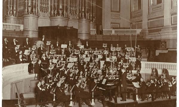 Archival black and white photograph of the Orchestra performing in Town Hall