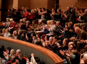 Photograph of people clapping at Symphony Hall