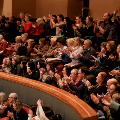 Photograph of people clapping at Symphony Hall