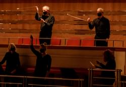 Photograph of members of the CBSO Chorus playing "whirligiggs", an unusual form of percussion.
