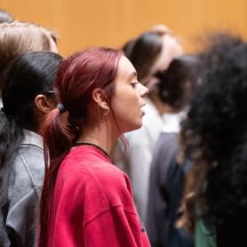 Photograph of a teenage girl singing in a Youth Chorus rehearsal
