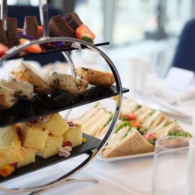 Photograph of cakes and sandwiches at an afternoon tea