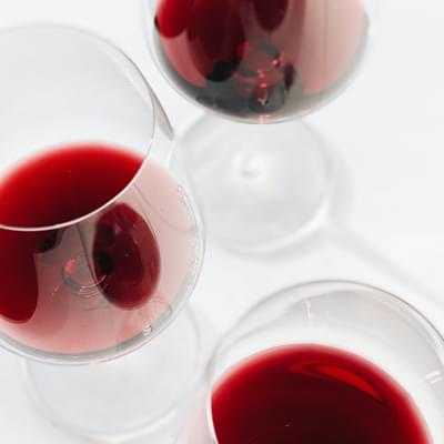 Photograph of red wine glasses.