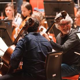 Photograph of Eduardo Vassallo laughing with the CBSO cello section