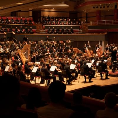 Photograph of the full orchestra and CBSO Chorus performing on stage at Symphony Hall