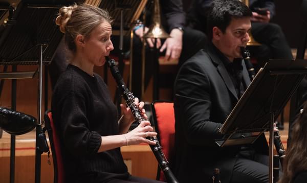 Photograph of Joanna Patton playing the clarinet in the orchestra