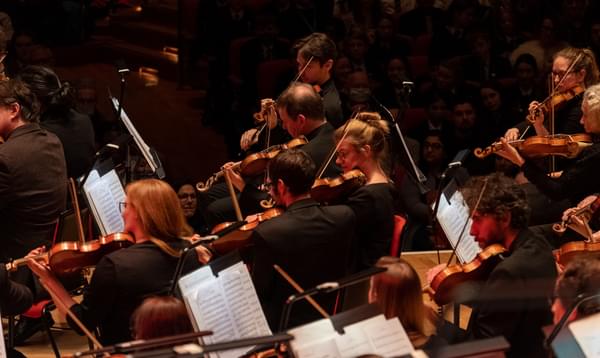 Photograph of the CBSO's violinists performing on-stage at Symphony Hall